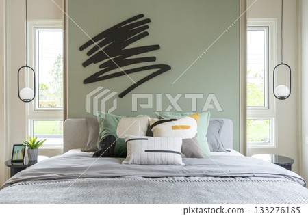 Modern bedroom interior with green wall and wall art with hanging lamp. Modern bedroom interior with green wall and wall art with hanging lamp. 133276185