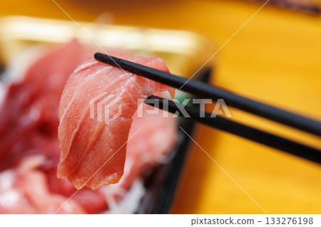 Fatty tuna held with chopsticks Fatty tuna held with chopsticks 133276198