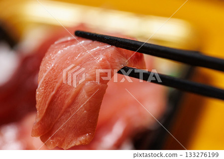 Fatty tuna held with chopsticks 133276199
