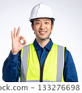A field worker wearing a safety vest makes an OK pose 133276698