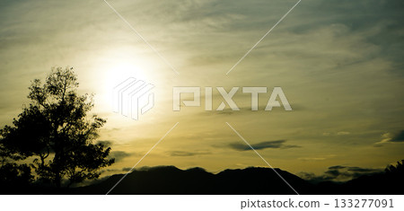 silhouette of trees and mountains with sunset background silhouette of trees and mountains with sunset background 133277091