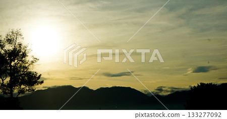 silhouette of trees and mountains with sunset background silhouette of trees and mountains with sunset background 133277092
