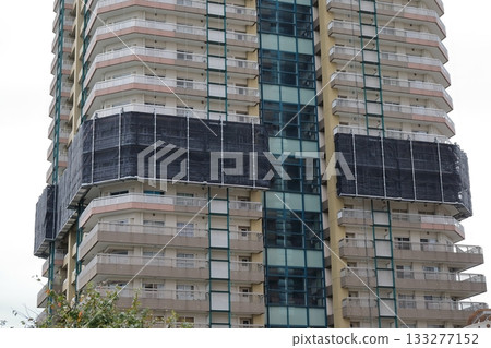 Tower apartment building undergoing repairs 133277152