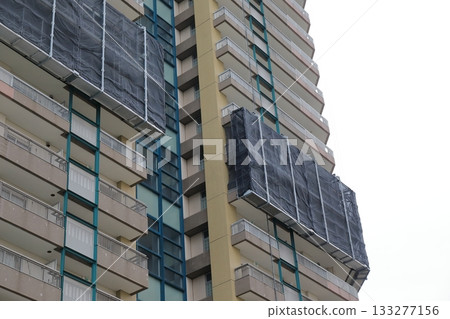 Tower apartment building undergoing repairs 133277156