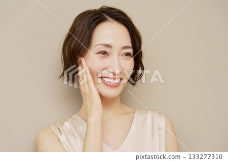 Middle-aged woman portrait brown background Middle-aged woman portrait brown background 133277310