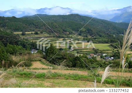 Scenery of a mountain village with terraced rice fields after the rice harvest Scenery of a mountain village with terraced rice fields after the rice harvest 133277452