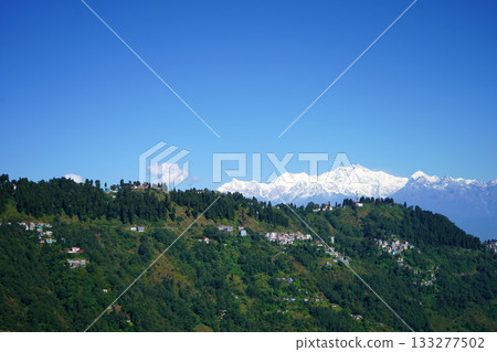 Lush Green Darjeeling Hills with the Majestic Snow Capped Kangchenjunga Peak Lush Green Darjeeling Hills with the Majestic Snow Capped Kangchenjunga Peak 133277502