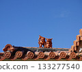 Okinawa's red tiled roofs and Shisa lions | Traditional houses shining against the blue sky 133277540