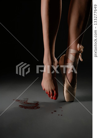 Dancer's bare foot on stage with pointe shoe and red marks on the floor 133277649