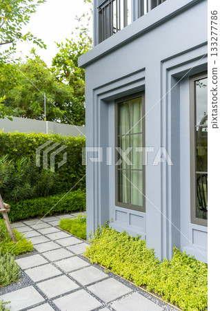 Design of landscaping of home garden backyard with brick walkway in summer. 133277786