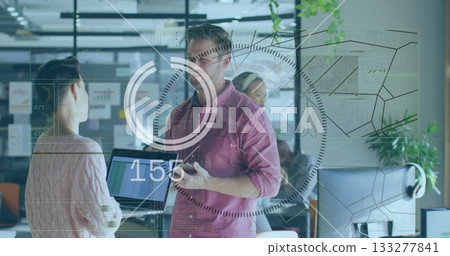 Man in red shirt holding smartphone and explaining data in office, with transparent display, laptop Man in red shirt holding smartphone and explaining data in office, with transparent display, laptop 133277841