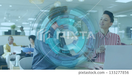 Collaborating professionals in business attire typing at office desk, with laptop, AR overlay Collaborating professionals in business attire typing at office desk, with laptop, AR overlay 133277856
