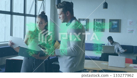 Reviewing papers colleagues wearing formal wear collaborating in office lounge, with smartphone 133277962