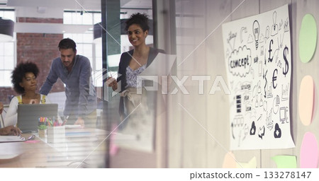 Reviewing printed documents professionals in suits collaborating in conference room with whiteboard Reviewing printed documents professionals in suits collaborating in conference room with whiteboard 133278147