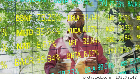Carrying two coffee cups, African American man standing under trees, with ticker overlay, bag strap Carrying two coffee cups, African American man standing under trees, with ticker overlay, bag strap 133278148