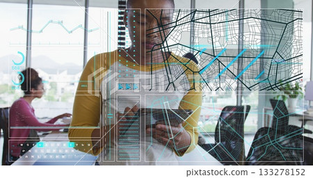 Person in mustard shirt using tablet, interacting with holographic map alongside coworker in office Person in mustard shirt using tablet, interacting with holographic map alongside coworker in office 133278152