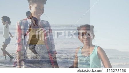 Splashing girl in turquoise top and shorts running in shallow surf on sandy shoreline, copy space 133278268