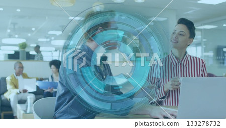Talking male colleague and typing female colleague at open office desk, with smartphone and laptop Talking male colleague and typing female colleague at open office desk, with smartphone and laptop 133278732