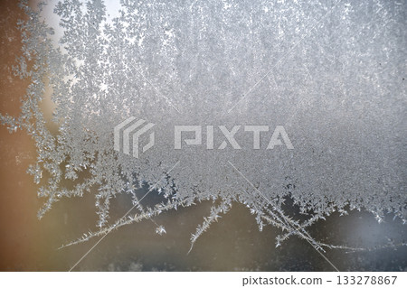Frosted Glass With Intricate Ice Crystals Creating Delicate Winter Pattern Across Surface 133278867