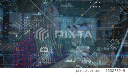 Speaking bearded man with dreadlocks and glasses using smartphone at cafe table, digital network 133278949