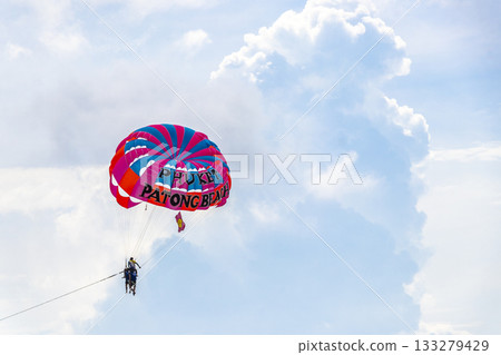 Patong Beach Phuket with parachute sport and parasailing activity Thailand. 133279429