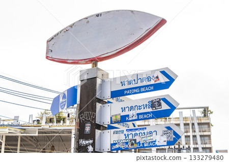 Surfboard and arrow beach direction sign signs Patong Phuket Thailand. Surfboard and arrow beach direction sign signs Patong Phuket Thailand. 133279480
