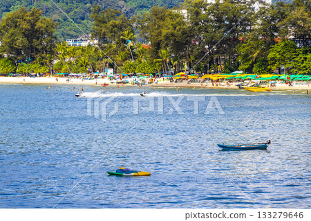 Patong Beach Phuket with people promenade sun loungers parasols Thailand. 133279646
