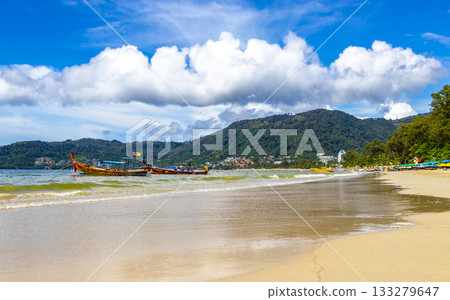 Patong Beach Phuket with promenade boats turquoise blue water Thailand. 133279647