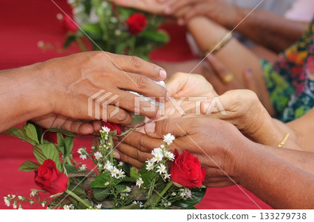 Close - up of hands of Thai pour water on elders' hands for blessings, Songkran Festival 133279738