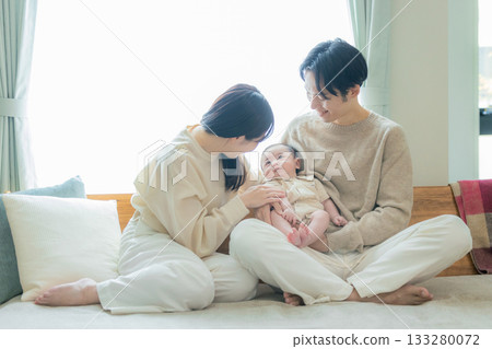 A couple holding a baby 133280072