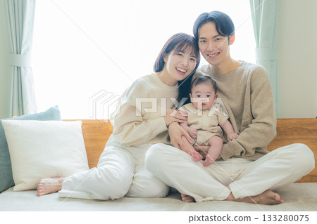 A couple holding a baby 133280075
