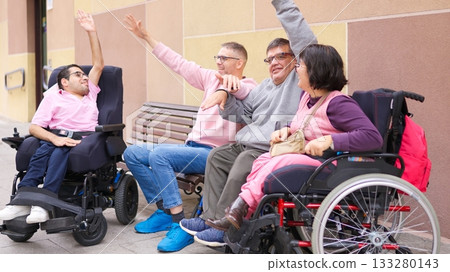 Diverse group of friends with physical disability raising hands together Diverse group of friends with physical disability raising hands together 133280143