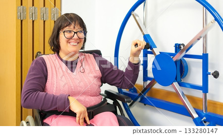 Woman with physical disability exercising arm and shoulder in rehabilitation Woman with physical disability exercising arm and shoulder in rehabilitation 133280147