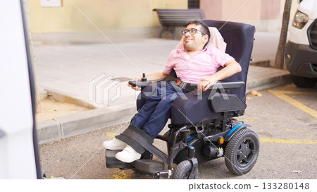 Man with physical disability in electric wheelchair riding outdoors for inclusion Man with physical disability in electric wheelchair riding outdoors for inclusion 133280148