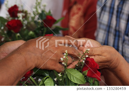 Close - up of hands of Thai pour water on elders' hands for blessings, Songkran Festival 133280459