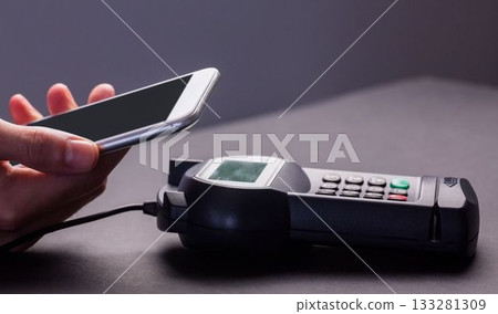 Man using smartphone to express pay 133281309