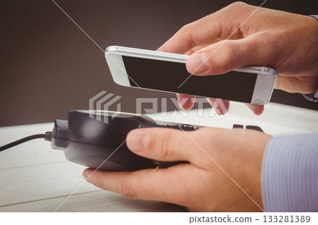 Man using smartphone to express pay Man using smartphone to express pay 133281389