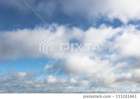 Layered cumulus and stratocumulus clouds are floating across flat design blue sky illustration 133281661