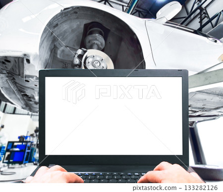 Blank screen on a laptop in an auto shop. 133282126