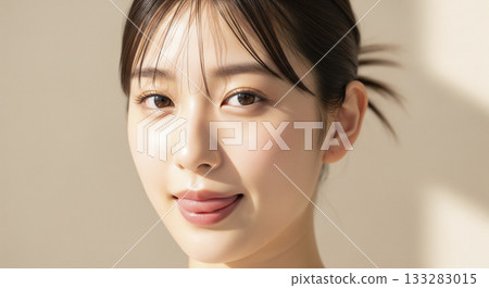 Skin care for a Japanese woman with clear skin sticking out her tongue 133283015