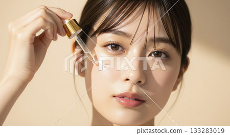 一位年輕的日本女性用滴管塗抹精華液 133283019