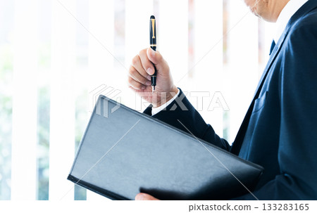 Businessman thinking by the window 133283165