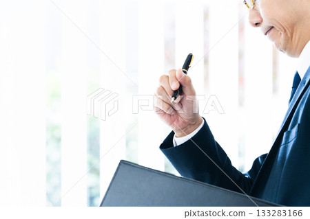 Businessman thinking by the window 133283166