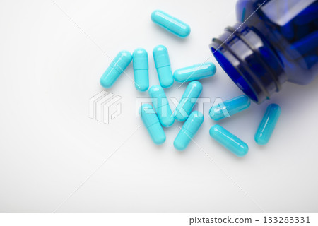 Health care background of pills and bottle on white surface flat lay 133283331