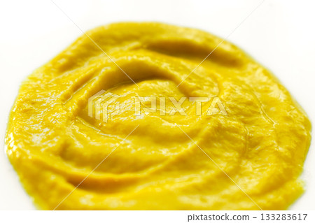 Yellow mustard on a white plate. Yellow mustard on a white plate. 133283617