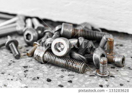 Old dirty stainless steel button head allen bolt and mechanical tools.  133283628