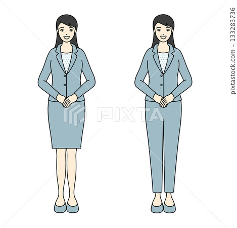 A female employee in a light blue business suit standing upright with her hands clasped A female employee in a light blue business suit standing upright with her hands clasped 133283736