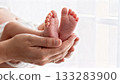 Newborn Baby Feet Close-up in Parent's Hands Gentle Touch 133283900