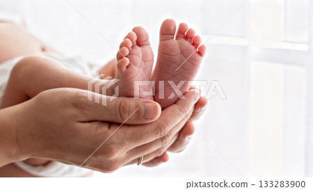 Newborn Baby Feet Close-up in Parent's Hands Gentle Touch Newborn Baby Feet Close-up in Parent's Hands Gentle Touch 133283900