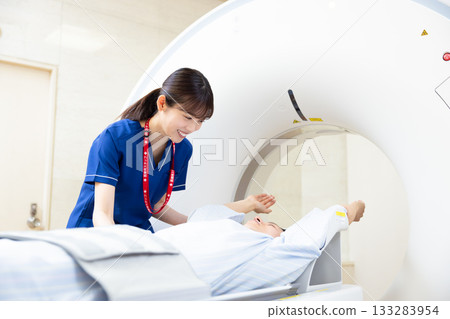 A man undergoing a CT scan with a radiologist. Photo courtesy of Denpa Gakuen, Tokyo Electronics College. A man undergoing a CT scan with a radiologist. Photo courtesy of Denpa Gakuen, Tokyo Electronics College. 133283954